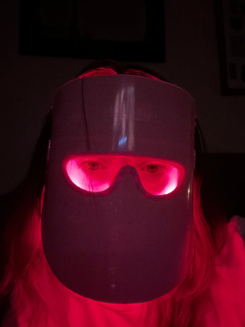 woman wearing red light therapy mask