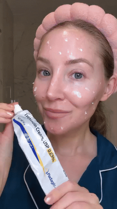 woman holding up bottle of tretinoin cream