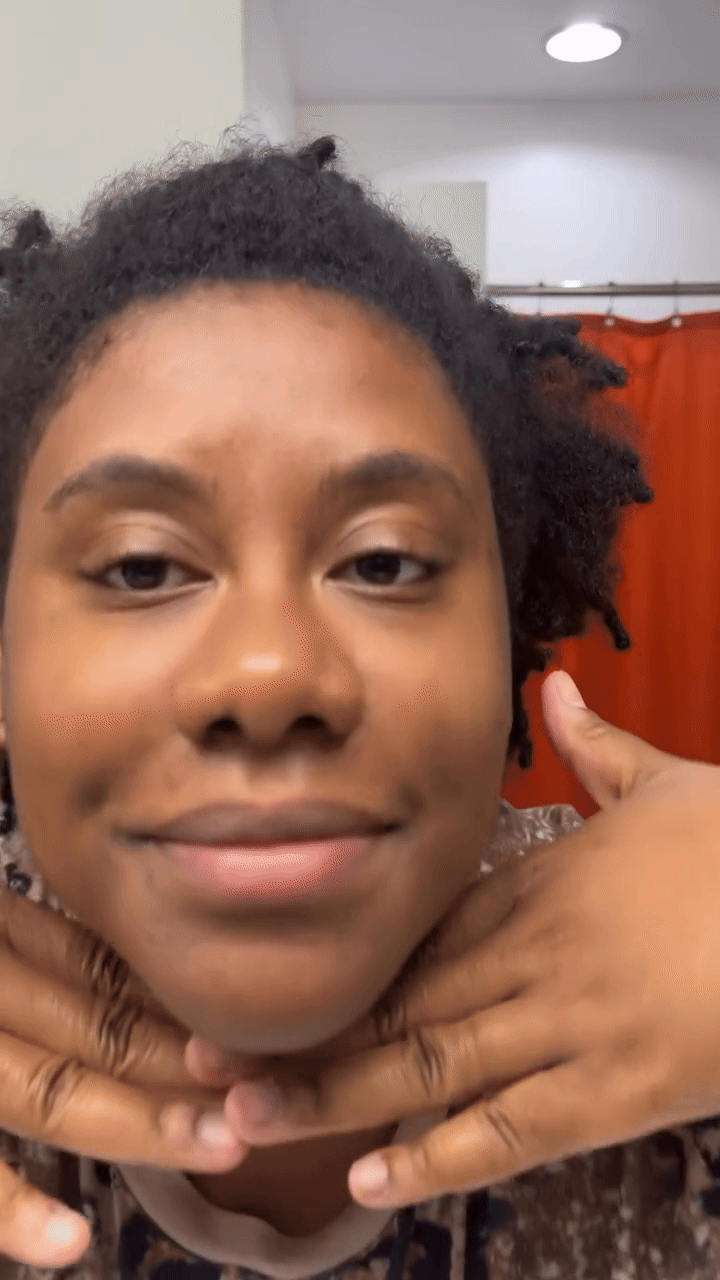 thecrystallinaperspective showing face up close turning head framing her chin with her hands