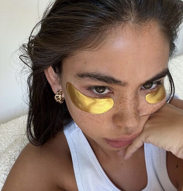 girl wearing gold under eye patches