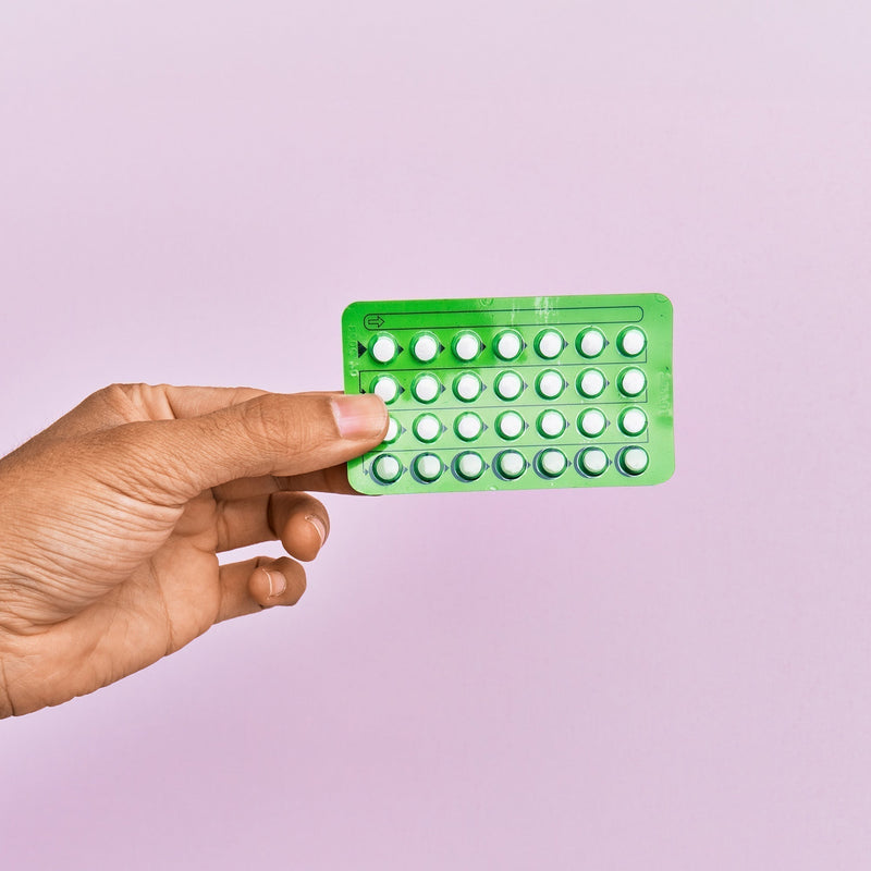 hand holding monthly pills